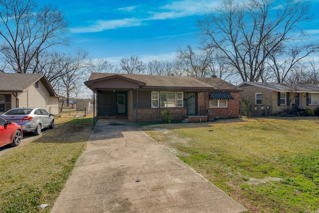 view of front of house featuring driveway, a front lawn, and brick siding