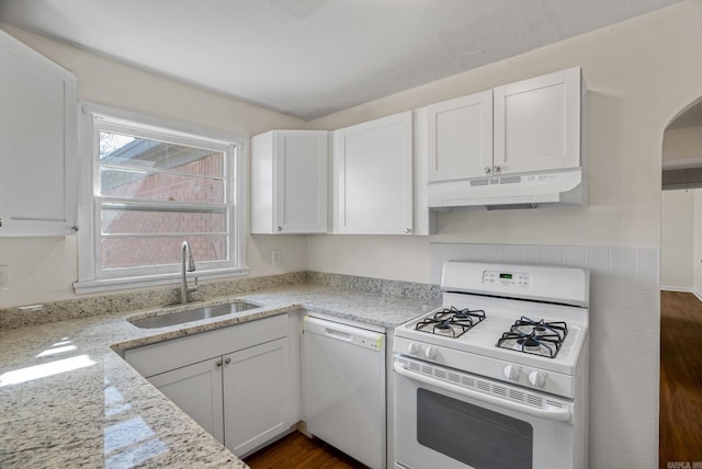 kitchen featuring white appliances, a sink, white cabinetry, and under cabinet range hood