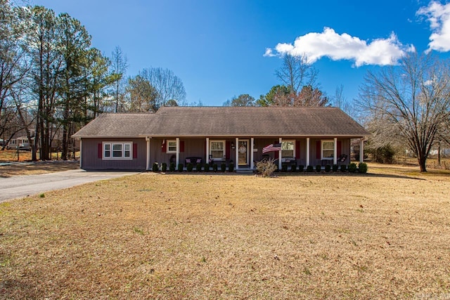 ranch-style house featuring a porch and a front lawn