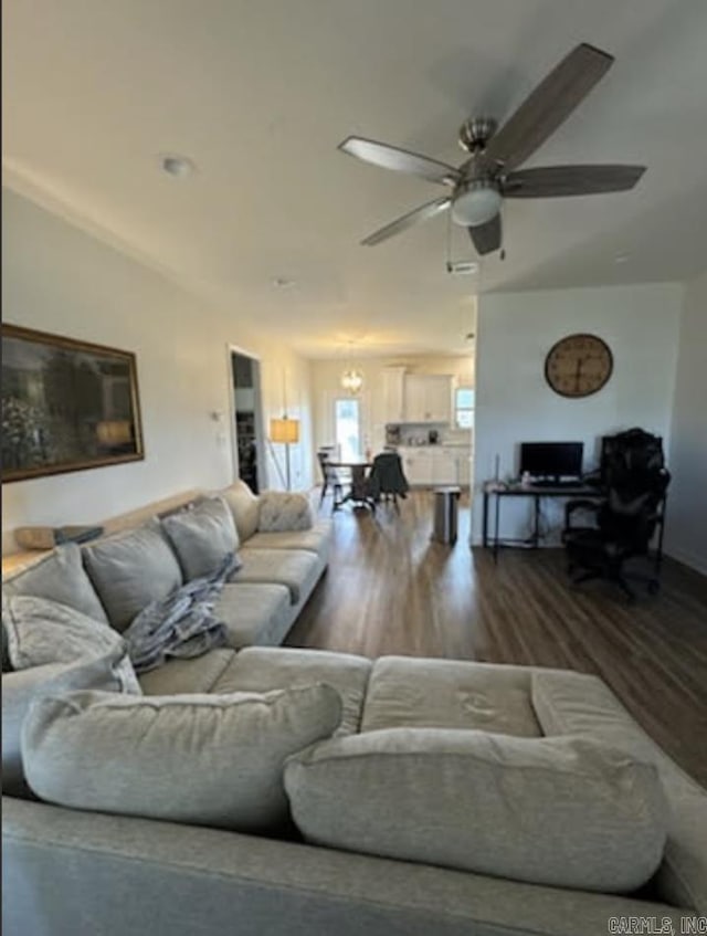 living area featuring a ceiling fan and wood finished floors