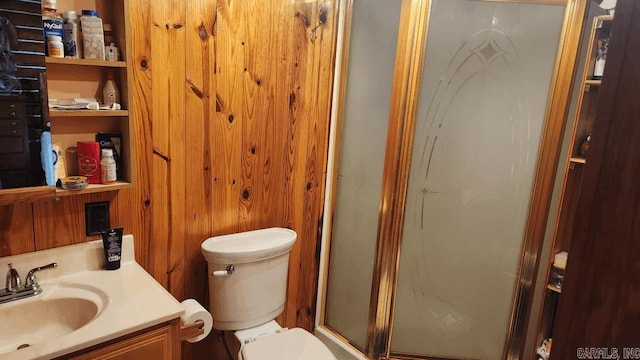 full bathroom featuring a shower stall, toilet, and vanity