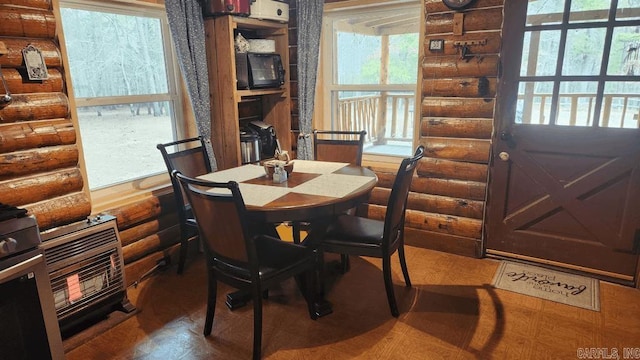 dining room featuring log walls