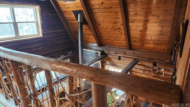 stairs featuring beam ceiling and wooden walls