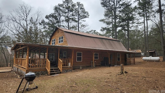 exterior space with covered porch, metal roof, and a gambrel roof