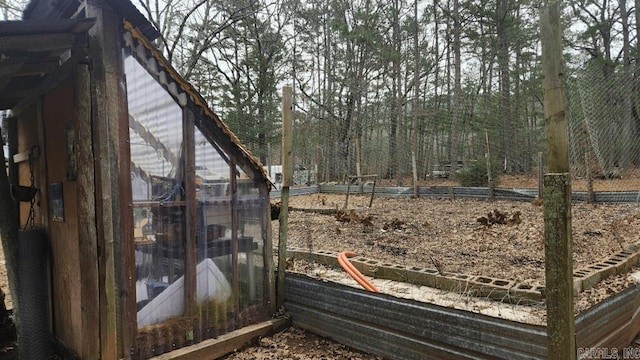 view of yard with an outbuilding and a greenhouse