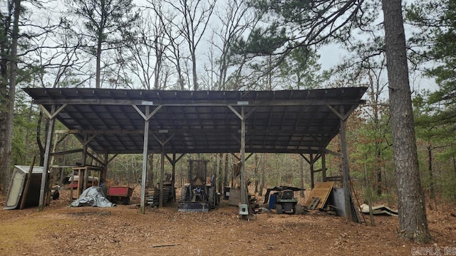 surrounding community with a carport, an outbuilding, and dirt driveway