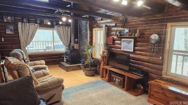 living area with a wood stove, log walls, and beam ceiling