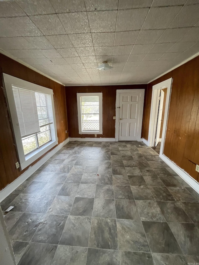 interior space with wooden walls and baseboards