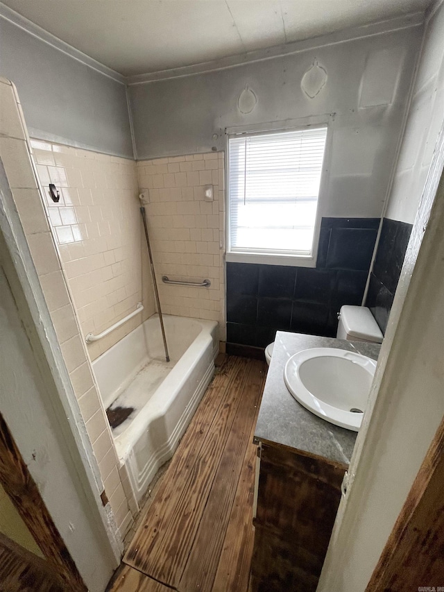 full bath with toilet, wood finished floors, a bathtub, walk in shower, and vanity