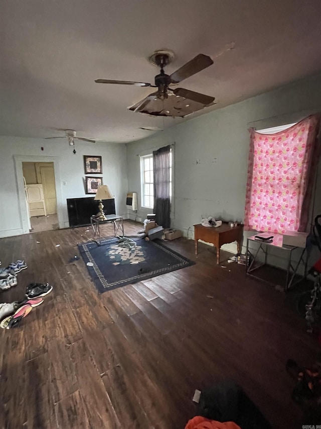 unfurnished living room with wood finished floors and a ceiling fan