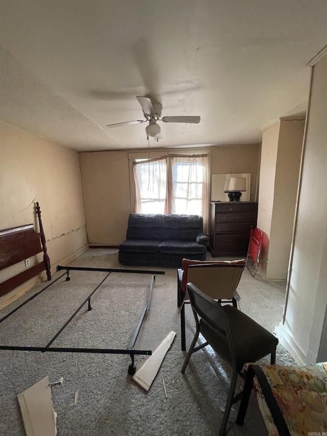 carpeted living area with ceiling fan