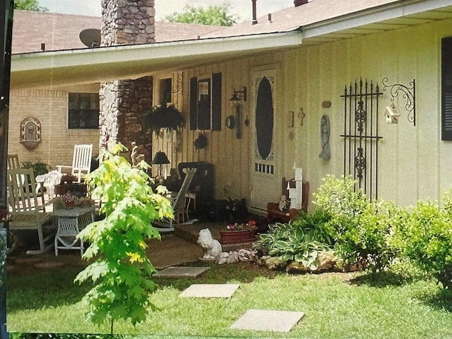 view of exterior entry featuring a chimney