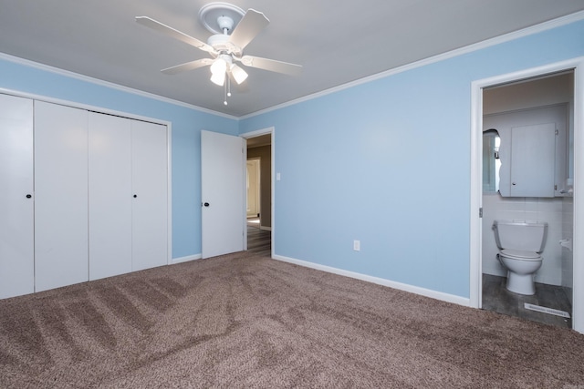 unfurnished bedroom featuring ornamental molding, a closet, carpet, and connected bathroom