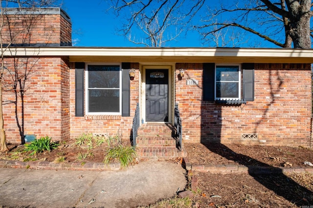 entrance to property with crawl space and brick siding