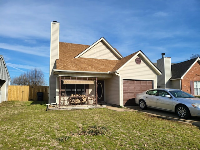 view of front of house with roof with shingles, an attached garage, a front yard, fence, and driveway