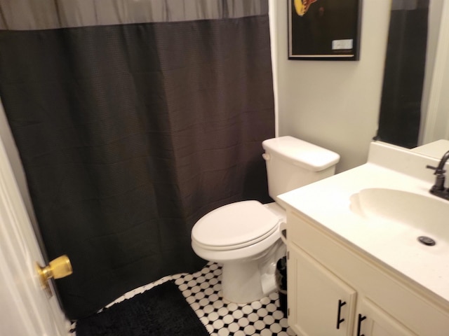 full bathroom with toilet and vanity