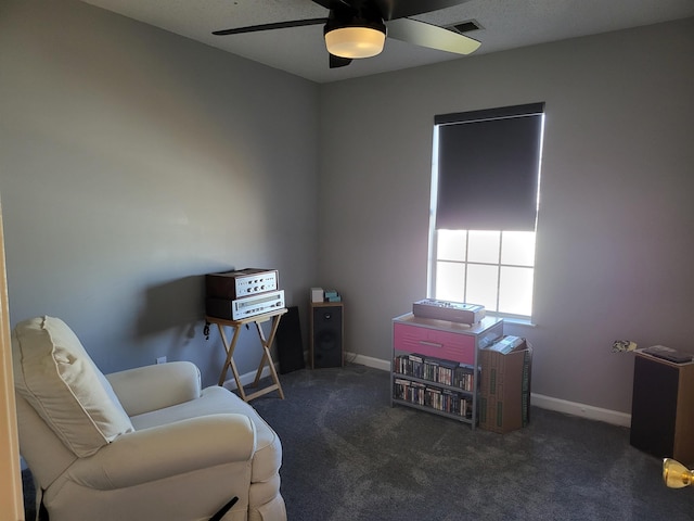 sitting room featuring ceiling fan, carpet flooring, visible vents, and baseboards