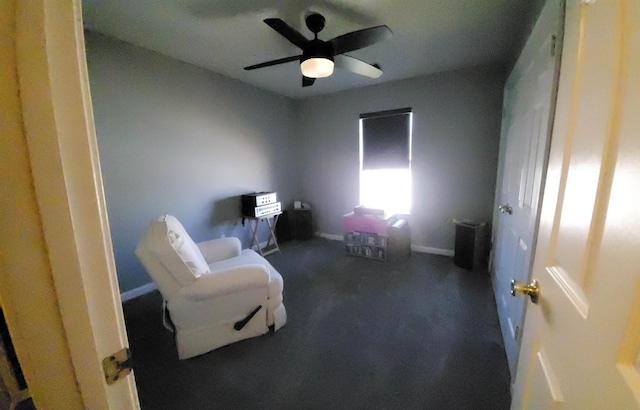 sitting room with carpet, ceiling fan, and baseboards