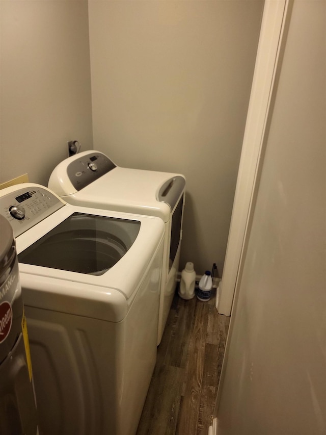 laundry area featuring laundry area, independent washer and dryer, and dark wood finished floors