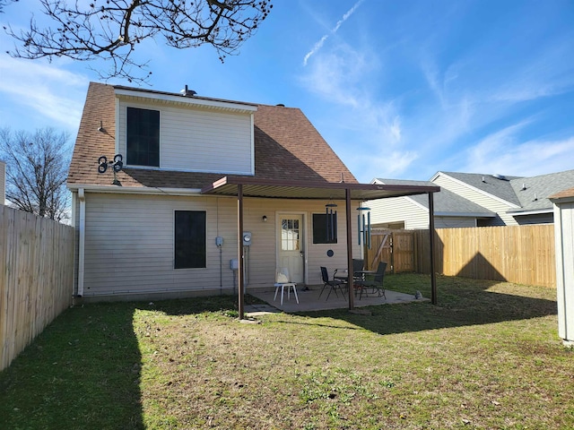 back of property featuring a patio area, a fenced backyard, a shingled roof, and a yard