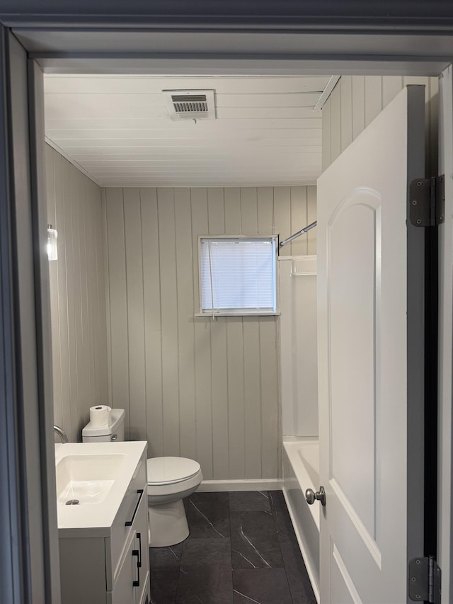 bathroom with toilet, visible vents, vanity, marble finish floor, and tub / shower combination