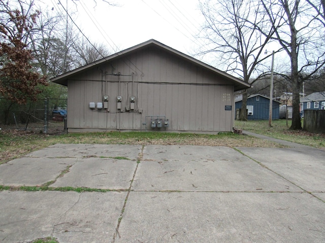 view of side of home featuring fence