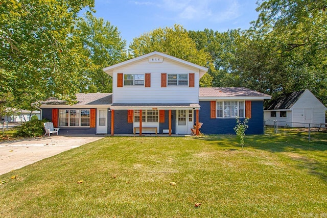 view of front of home with concrete driveway, a porch, a front yard, and fence