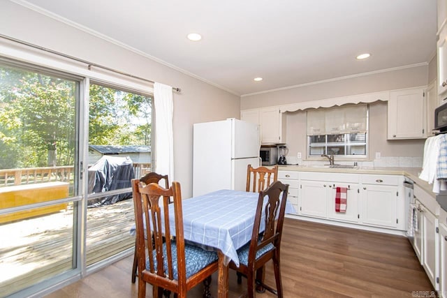 kitchen with ornamental molding, white cabinets, dark wood-type flooring, and freestanding refrigerator