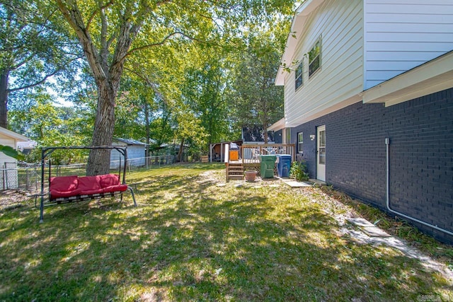 view of yard with fence and a deck