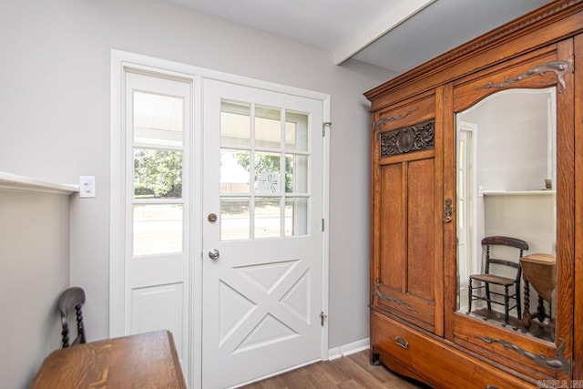 entryway with baseboards and wood finished floors