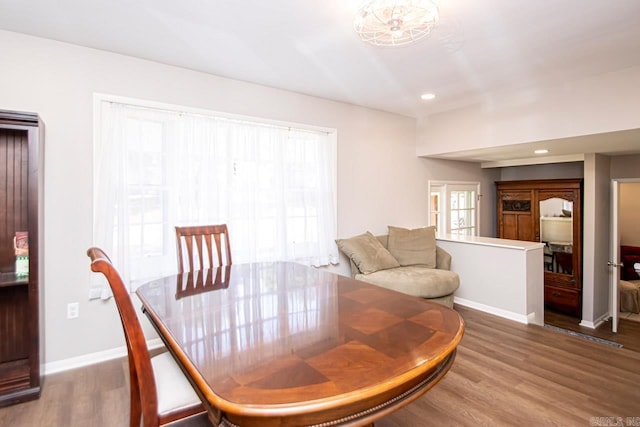 dining room featuring recessed lighting, wood finished floors, and baseboards