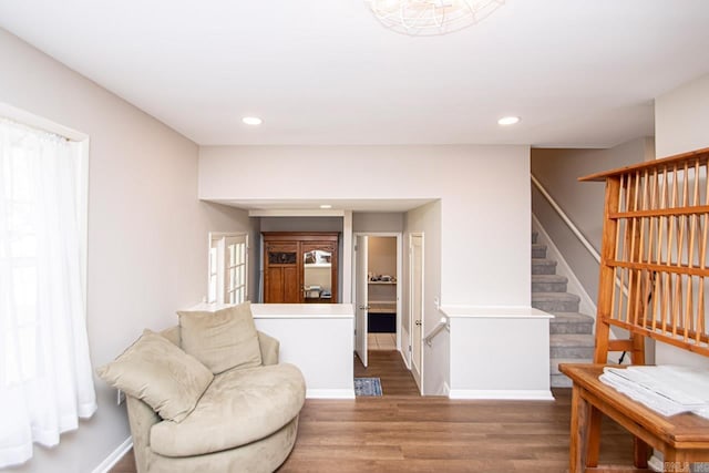 living area featuring stairs, recessed lighting, baseboards, and wood finished floors