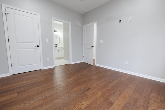 interior space with baseboards and wood finished floors