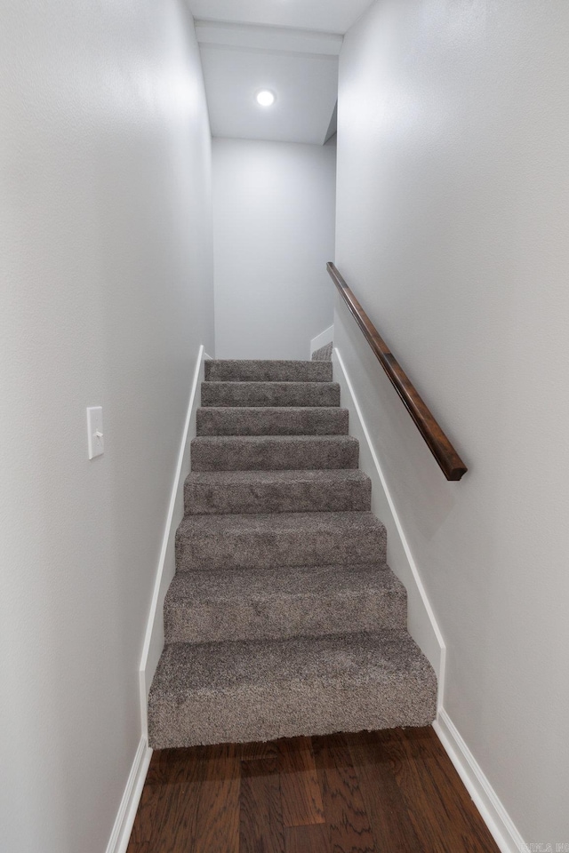 stairs with baseboards and wood finished floors