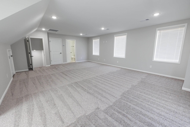 interior space with carpet flooring, visible vents, and baseboards