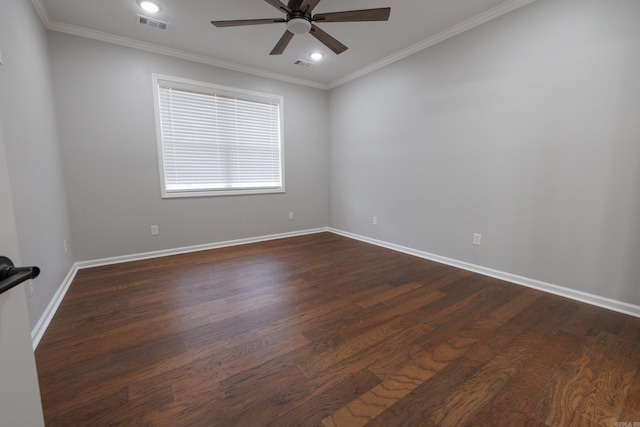 empty room with baseboards, dark wood-style flooring, visible vents, and crown molding