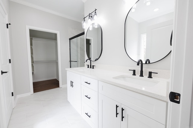 full bathroom featuring double vanity, baseboards, ornamental molding, and a sink