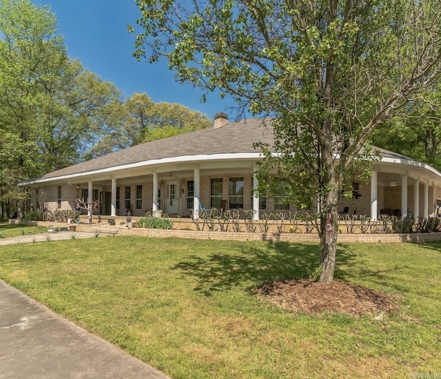 farmhouse featuring a front lawn and a chimney