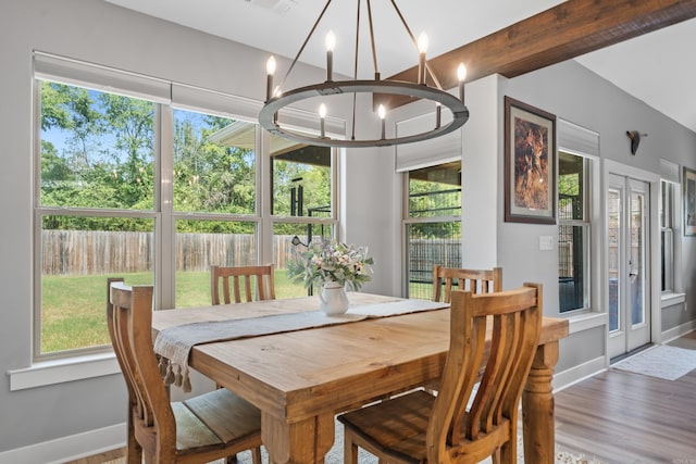 dining space with an inviting chandelier, visible vents, baseboards, and wood finished floors