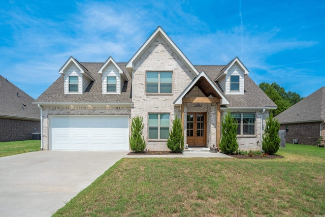 view of front facade featuring brick siding, a shingled roof, concrete driveway, a garage, and a front lawn