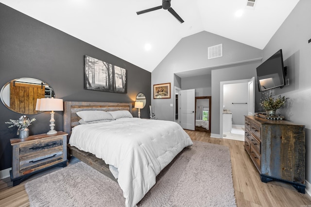 bedroom with light wood finished floors, visible vents, baseboards, ceiling fan, and high vaulted ceiling