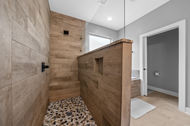 full bath featuring a tub, baseboards, visible vents, and a walk in shower