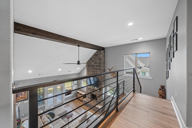 corridor with baseboards, visible vents, lofted ceiling with beams, wood finished floors, and recessed lighting