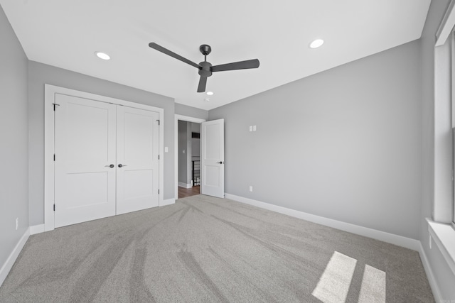 unfurnished bedroom with carpet, recessed lighting, a closet, a ceiling fan, and baseboards