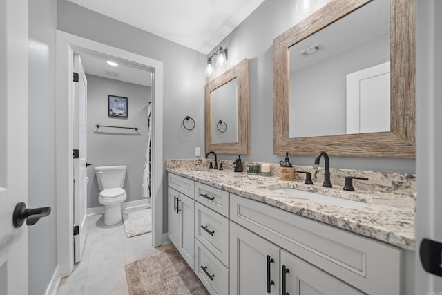 full bathroom with toilet, double vanity, a sink, and visible vents