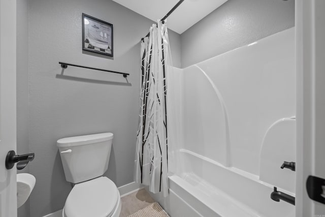 bathroom with toilet and shower / bath combo with shower curtain