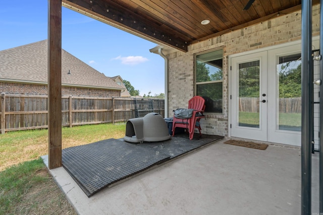 view of patio featuring french doors and fence