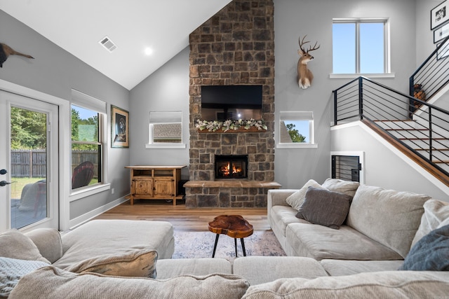 living area with plenty of natural light, a fireplace, and visible vents