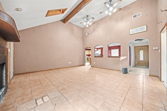 unfurnished living room with light tile patterned floors, visible vents, arched walkways, beamed ceiling, and high vaulted ceiling