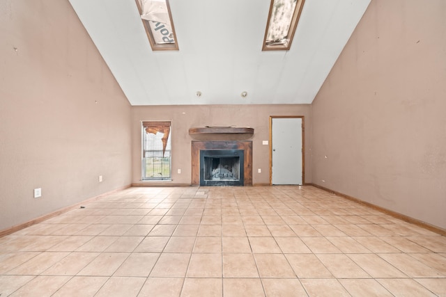 unfurnished living room with high vaulted ceiling, light tile patterned flooring, a fireplace, and baseboards